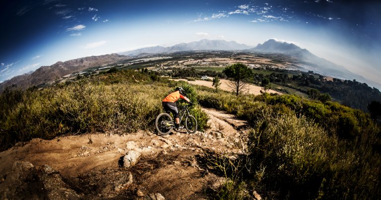 1-mountain-biker-on-a-cross-country-back-road-trail-470648932_5760x3025-768x403